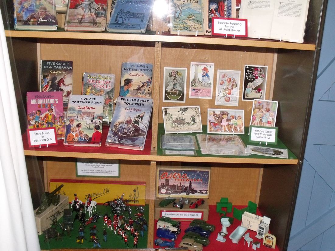 A display of children's books and toys in a museum